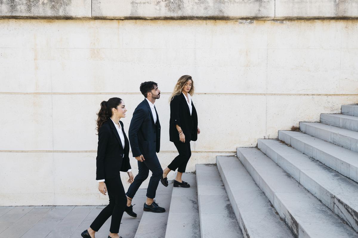 Three professionals walking down the steps together; you are the author now